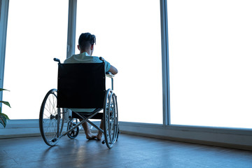 People with disabilities are sitting in a wheelchair. Looking into the window, the rear view, the...