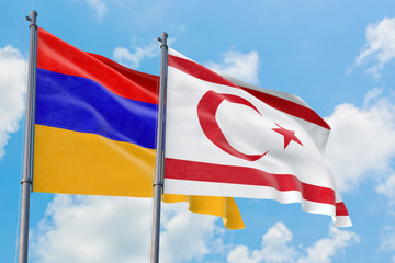 Northern Cyprus and Armenia flags waving in the wind against white cloudy blue sky together. Diplomacy concept, international relations.