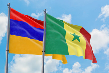 Senegal and Armenia flags waving in the wind against white cloudy blue sky together. Diplomacy concept, international relations.