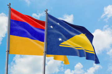 Tokelau and Armenia flags waving in the wind against white cloudy blue sky together. Diplomacy concept, international relations.