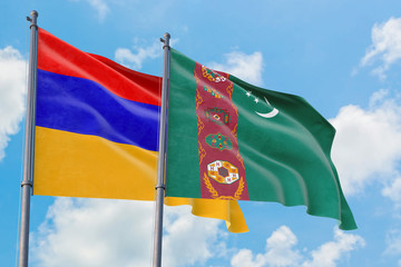 Turkmenistan and Armenia flags waving in the wind against white cloudy blue sky together. Diplomacy concept, international relations.