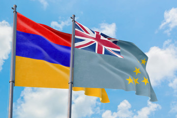 Tuvalu and Armenia flags waving in the wind against white cloudy blue sky together. Diplomacy...