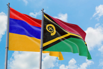 Vanuatu and Armenia flags waving in the wind against white cloudy blue sky together. Diplomacy concept, international relations.