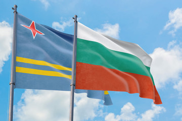 Bulgaria and Aruba flags waving in the wind against white cloudy blue sky together. Diplomacy concept, international relations.