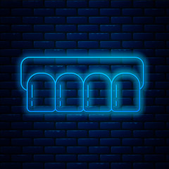 Glowing neon line Dentures model icon isolated on brick wall background. Teeth of the upper jaw. Dental concept. Vector Illustration © Oksana
