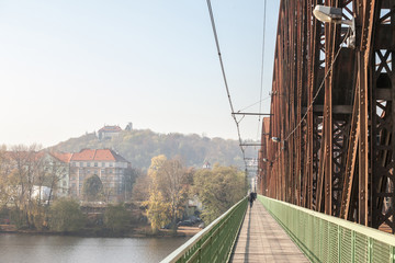 Obraz premium Vysehrad Railway bridge, also called vysehradsky zeleznicni most, in Prague, Czech Republic. It is a metal steel bridge for train transportation in Vyton district over Vltava river