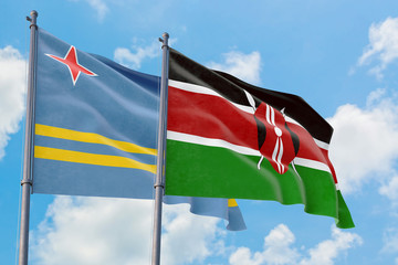 Kenya and Aruba flags waving in the wind against white cloudy blue sky together. Diplomacy concept, international relations.