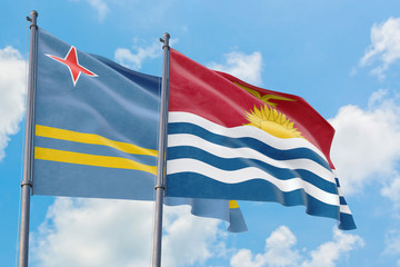Kiribati and Aruba flags waving in the wind against white cloudy blue sky together. Diplomacy concept, international relations.
