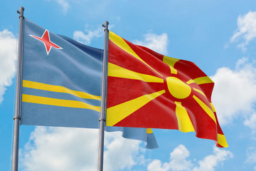 Macedonia and Aruba flags waving in the wind against white cloudy blue sky together. Diplomacy concept, international relations.