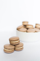 Coffe macaron in a white plate on a white isolated background
