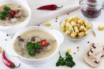 mushroom soup in a white plate and crackers