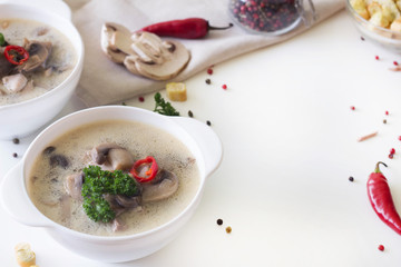 mushroom soup in a white plate and crackers