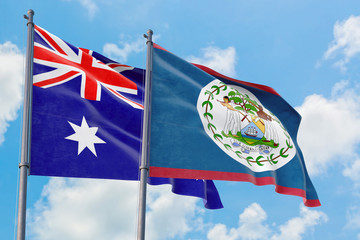 Belize and Australia flags waving in the wind against white cloudy blue sky together. Diplomacy concept, international relations.