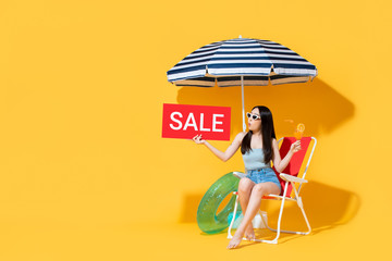 Banner of surprised Asian woman in summer outfit showing sale sign