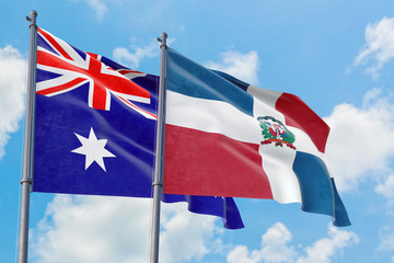Dominican Republic and Australia flags waving in the wind against white cloudy blue sky together. Diplomacy concept, international relations.