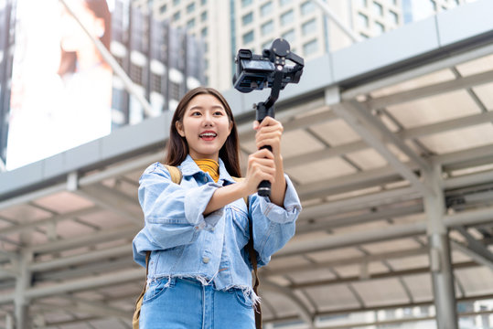 Asian woman tourist travel vlogger taking selfie video in the city