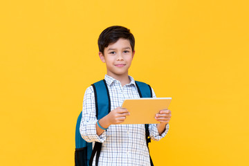 Handsome young boy in backpack holding a tablet - Powered by Adobe