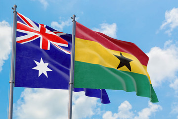 Ghana and Australia flags waving in the wind against white cloudy blue sky together. Diplomacy concept, international relations.