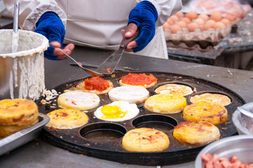 The chef prepares a meal in the food market in China, street food in summer
