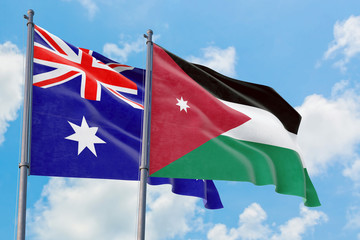 Fototapeta premium Jordan and Australia flags waving in the wind against white cloudy blue sky together. Diplomacy concept, international relations.