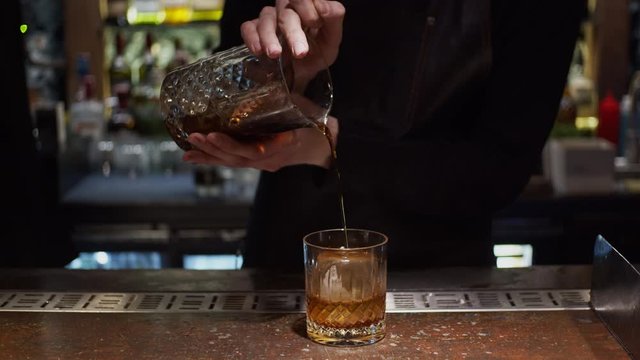 Process of making alcohol cocktail, slow motion, shallow depth of field