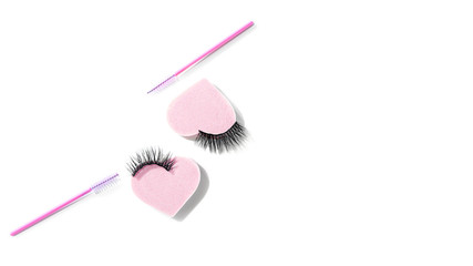 Magnetic fake eyelashes,  mascara pink brushes, eye makeup heart shape sponge isolated on white background. Eyelash extension tool concept, beauty treatment, improving physical appearance. Copy space