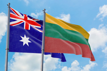 Lithuania and Australia flags waving in the wind against white cloudy blue sky together. Diplomacy concept, international relations.