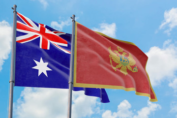 Montenegro and Australia flags waving in the wind against white cloudy blue sky together. Diplomacy concept, international relations.