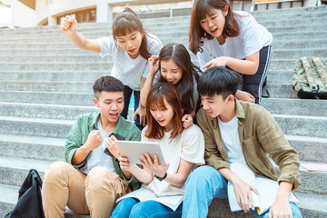 Group of students studying on the stairs  at campus