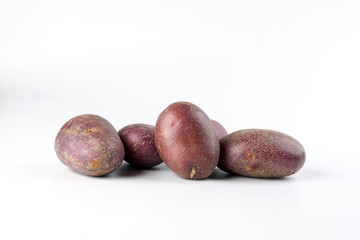 Purple color small baby potato on white background