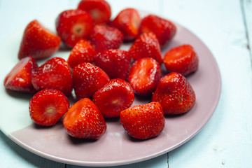 Fresh red strawberries in ceramic plate