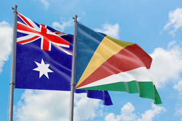 Seychelles and Australia flags waving in the wind against white cloudy blue sky together. Diplomacy concept, international relations.