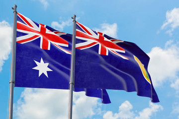 Turks And Caicos Islands and Australia flags waving in the wind against white cloudy blue sky together. Diplomacy concept, international relations.