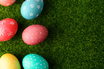 Fototapeta na wymiar Easter greetings. Easter painted eggs on green grass. Spring religious holiday Easter.