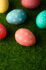 Easter greetings. Easter painted eggs on green grass. Easter religious holiday Easter. Vertical frame with space.