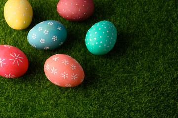 Easter greetings. Easter painted eggs on green grass. Spring religious holiday Easter.