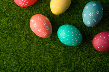 Fototapeta na wymiar Easter eggs colored on green grass. Congratulations on Easter. Horizontal frame.
