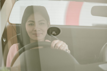 Asian girl smiling  relaxing sitting and prepare drive safety