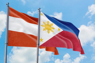 Philippines and Austria flags waving in the wind against white cloudy blue sky together. Diplomacy concept, international relations.