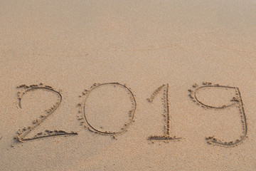 Abstract message Year 2019 written on beach sand