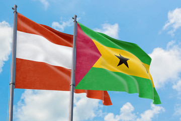 Sao Tome And Principe and Austria flags waving in the wind against white cloudy blue sky together....