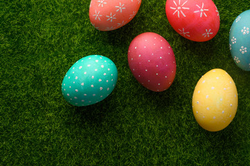 Easter colored eggs on green grass.Flat lay