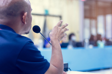 businessman speech and speaking with microphones in seminar room.