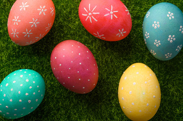 Easter colored eggs on green grass.Flat lay