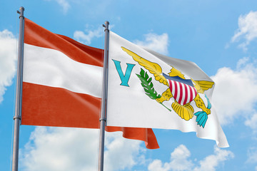 United States Virgin Islands and Austria flags waving in the wind against white cloudy blue sky together. Diplomacy concept, international relations.