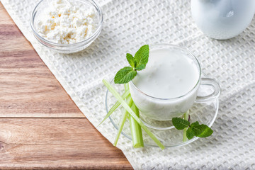 Pouring homemade kefir, yogurt with probiotics. Probiotic cold sour-milk drink. Fashionable food and drinks.
