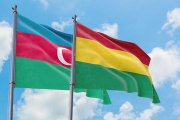 Bolivia and Azerbaijan flags waving in the wind against white cloudy blue sky together. Diplomacy concept, international relations.