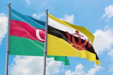 Brunei and Azerbaijan flags waving in the wind against white cloudy blue sky together. Diplomacy concept, international relations.