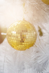 Golden Ball on White Christmas Tree