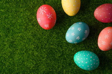 Easter greetings. Easter painted eggs on green grass. Spring religious holiday Easter.